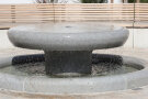 Aus dem neuen Dorfbrunnen tropft Wasser.
