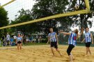 Eine Beachvollyeballmannschaft spielt sich den Ball zu.